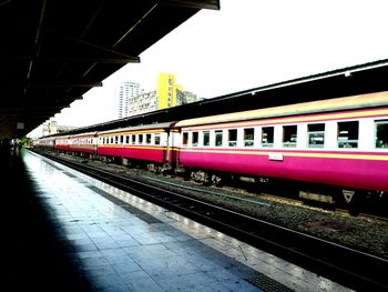 Train at railroad station against sky