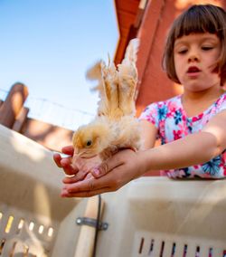 Portrait of cute girl with arms raised