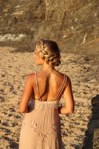 Woman looking at camera while standing on beach