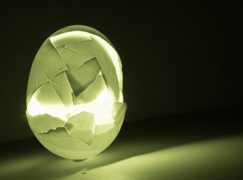 Close-up of illuminated lighting equipment against black background