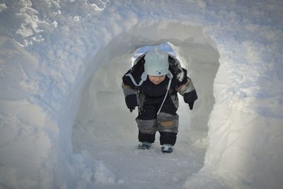 Child in snow tunnel