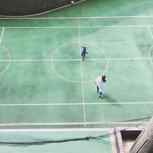 High angle view of family walking on basketball court