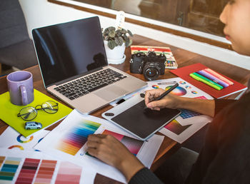 High angle view of woman technologies on table