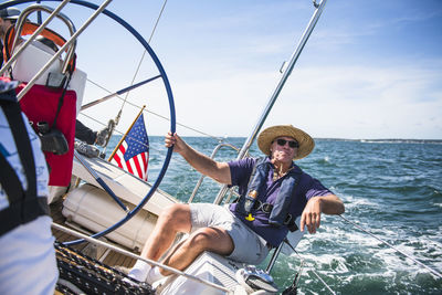 Middle aged man sailing on a sunny day