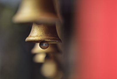 Close-up of bells hanging in row