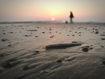 Scenic view of beach against sky during sunset