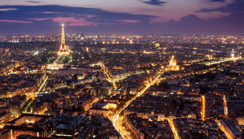 Aerial view of illuminated city buildings at night