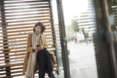 Smiling businesswoman using cell phone