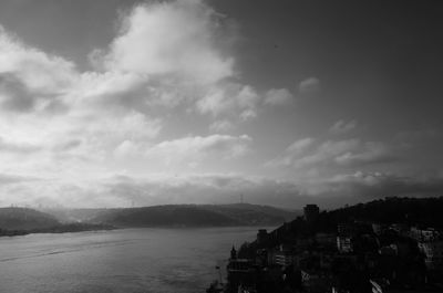 High angle view of townscape by sea against sky