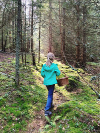 Rear view of woman walking in forest