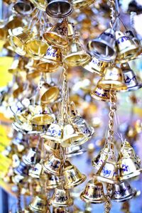 Close-up of decorations hanging in market for sale