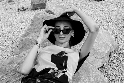 Portrait of young woman wearing sunglasses on beach