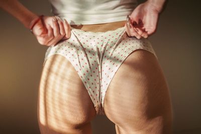 Midsection of woman standing at home