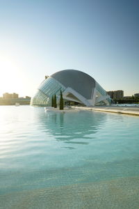 View of swimming pool in city against clear sky