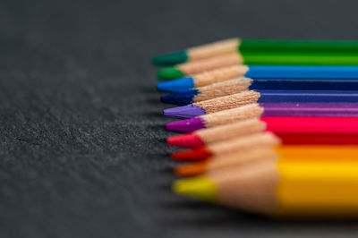 Close-up of multi colored pencils on table