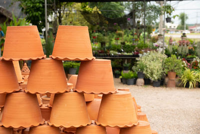 Stack of potted plants against trees