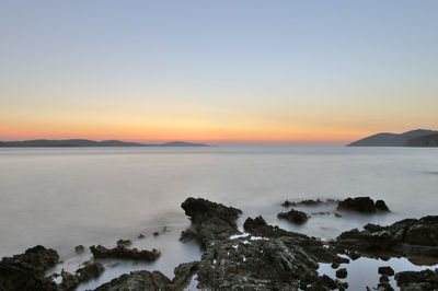 Scenic view of sea against sky at sunset