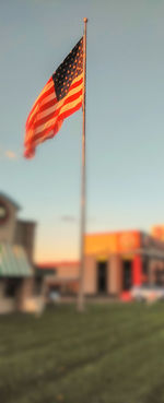 Low angle view of flag against sky during sunset