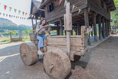 Full length of young woman standing on wood