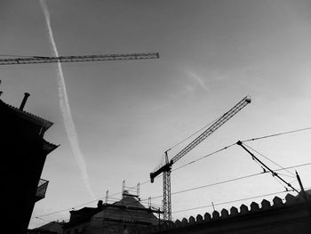 Low angle view of silhouette building against sky