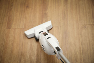 High angle view of vacuum cleaner on hardwood floor