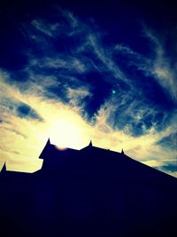 High section of built structure against cloudy sky