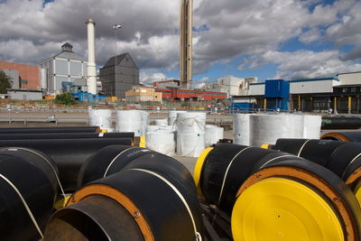 White and black pipes against factory