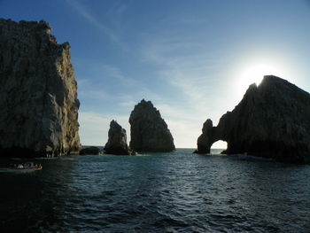 Arch of cabo san lucas and rock formation in sea against sky