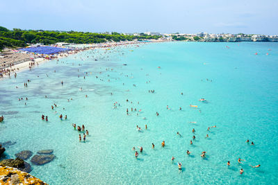 High angle view of people swimming in sea