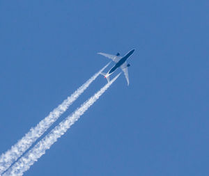 Low angle view of airplane flying in sky