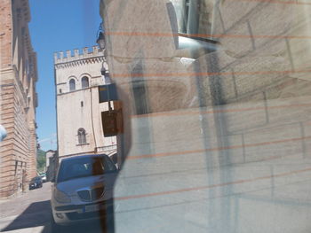 Reflection of buildings on road in city