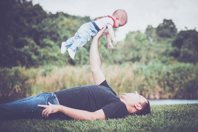 Side view of man lying down on land