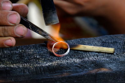 Cropped image of jeweller making ring 