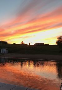 Scenic view of lake against orange sky