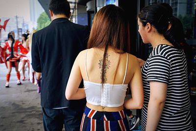 Rear view of couple standing outdoors