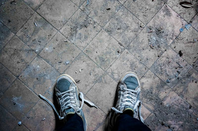 Low section of man standing on footpath