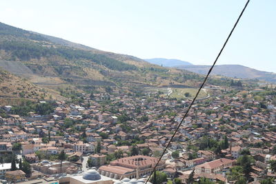 High angle view of townscape and mountains against clear sky