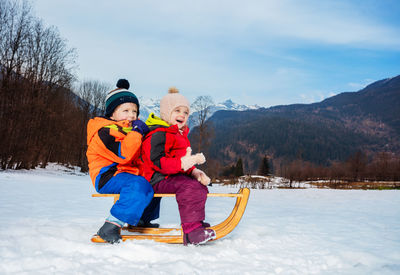 Full length of woman skiing on snow covered mountain