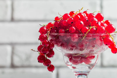 Close-up of red berries on glass