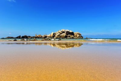 Scenic view of sea against clear blue sky