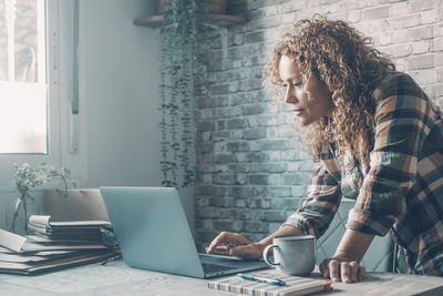 Young woman using laptop at office