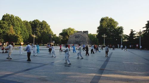 People on street in city against clear sky