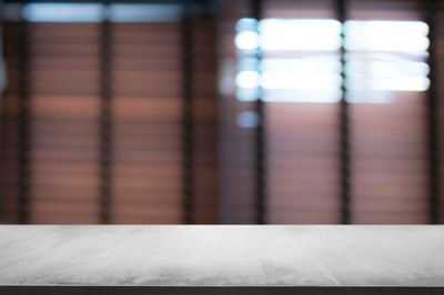 Close-up of empty table against wall