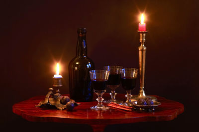 Illuminated tea light candles on table