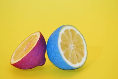 Close-up of fruits against yellow background