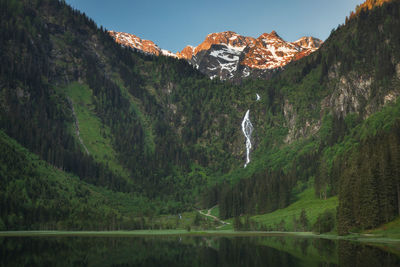 Scenic view of lake and mountains against sky