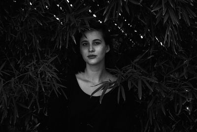 Close-up portrait of young woman in forest