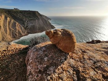 Rocks in sea against sky