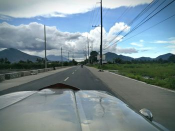 Cars on road against sky