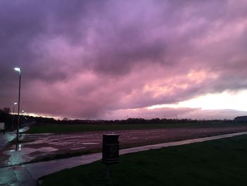 Scenic view of field against cloudy sky